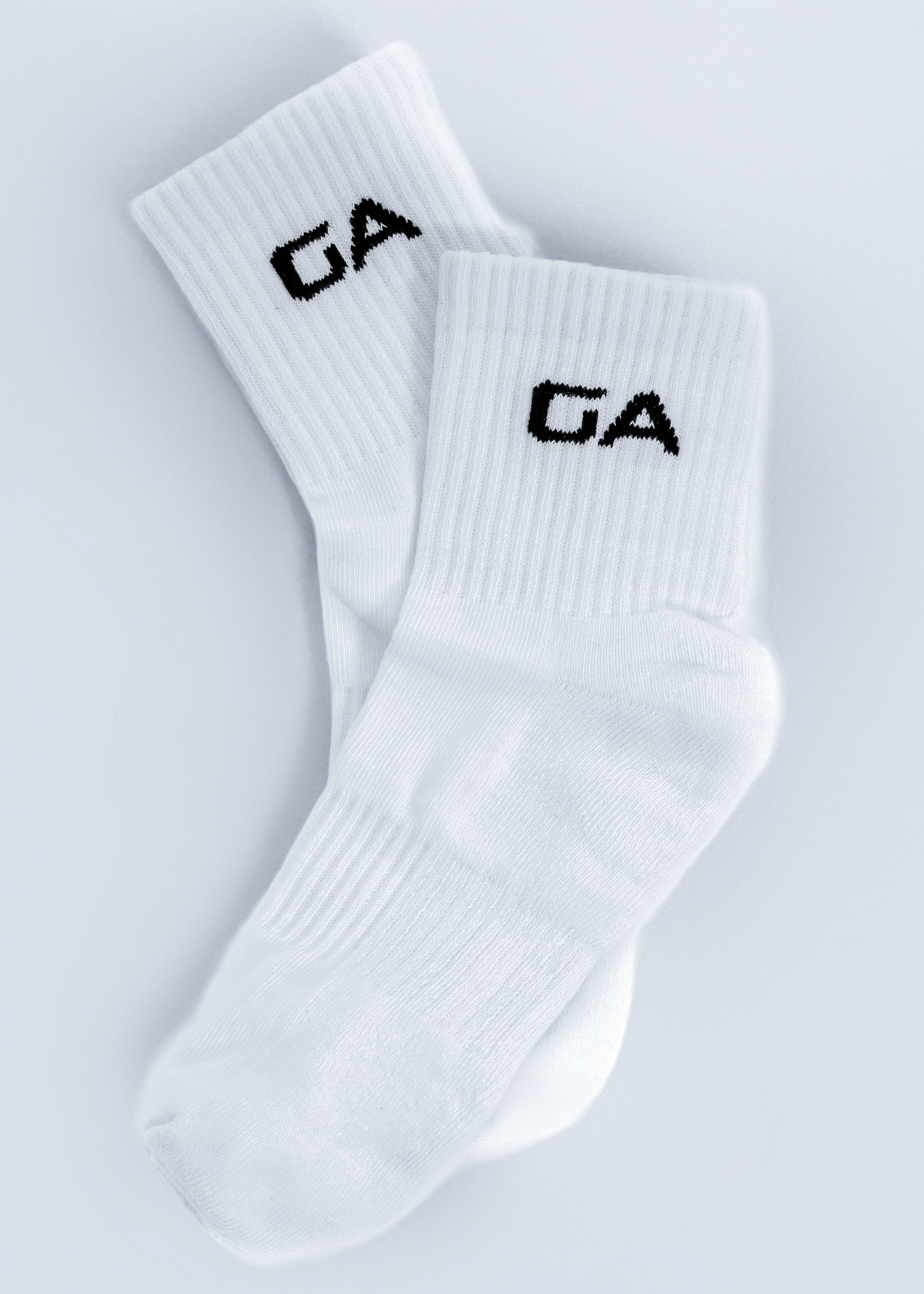 White socks with 'GA' logo on a light gray background - Gymathlete - GA endurance socks