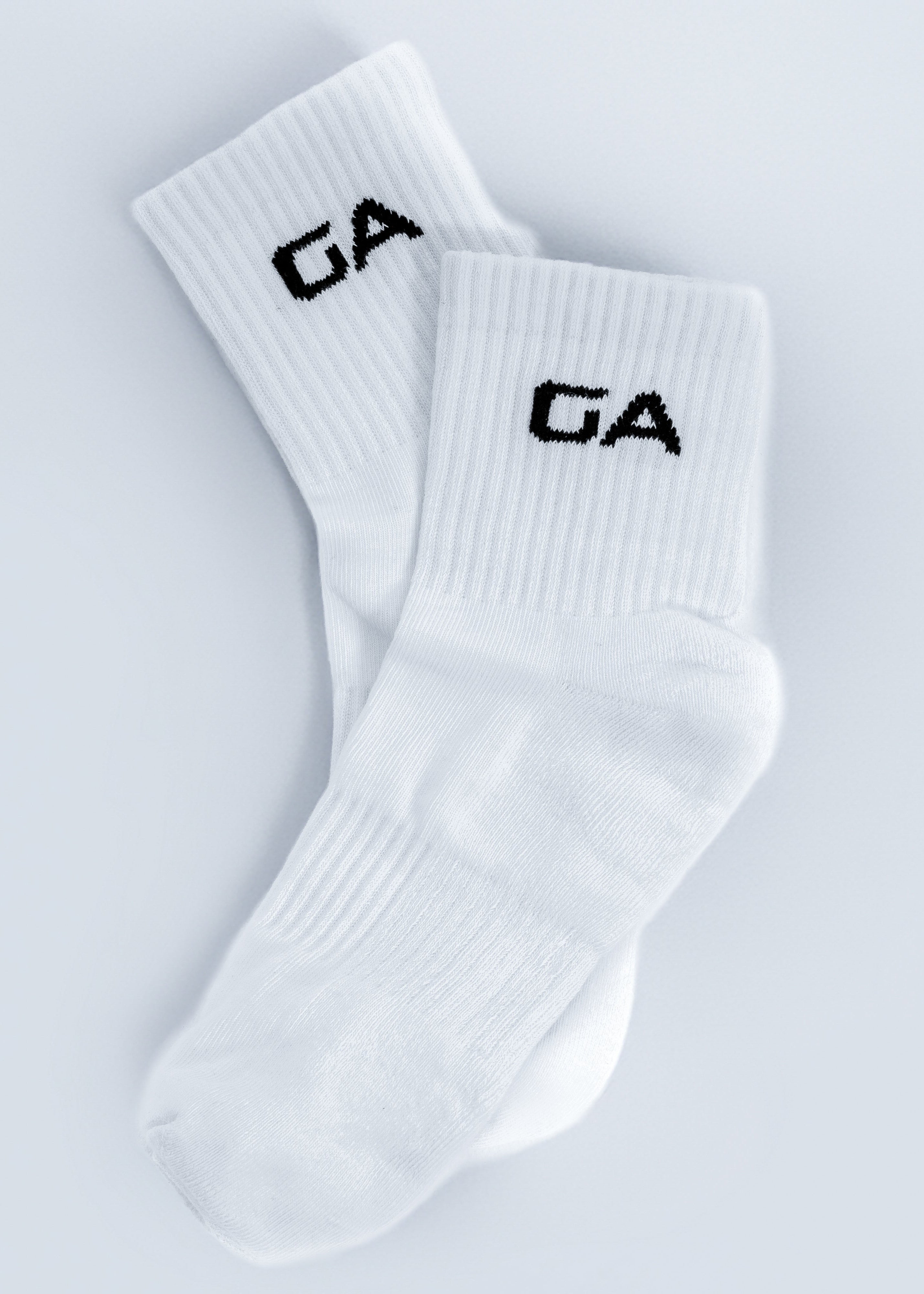 White socks with 'GA' logo on a light gray background - Gymathlete endurance socks white socks