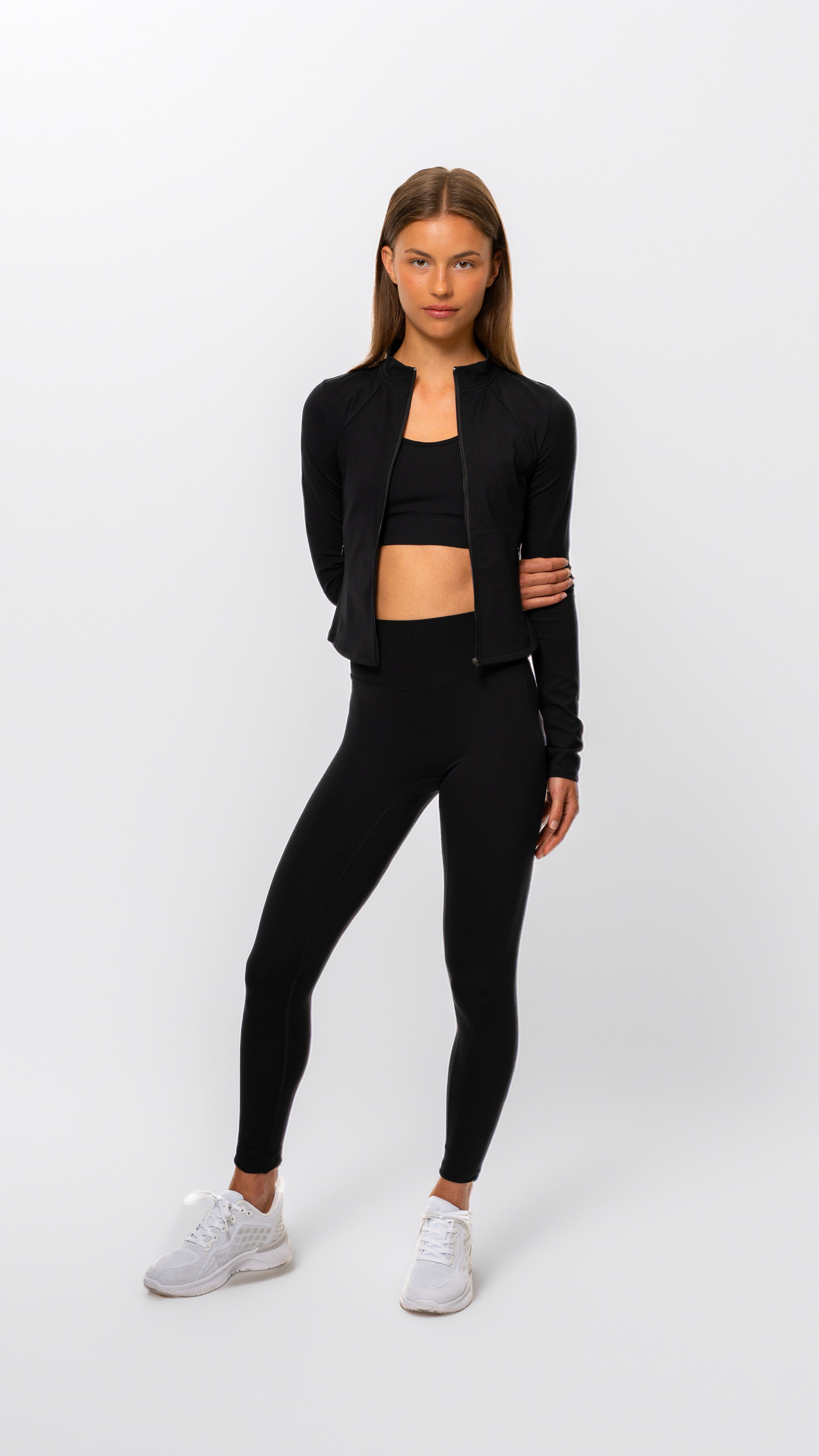 Woman wearing a black athletic outfit on a white background- Gymathlete - Women - Pulse leggings