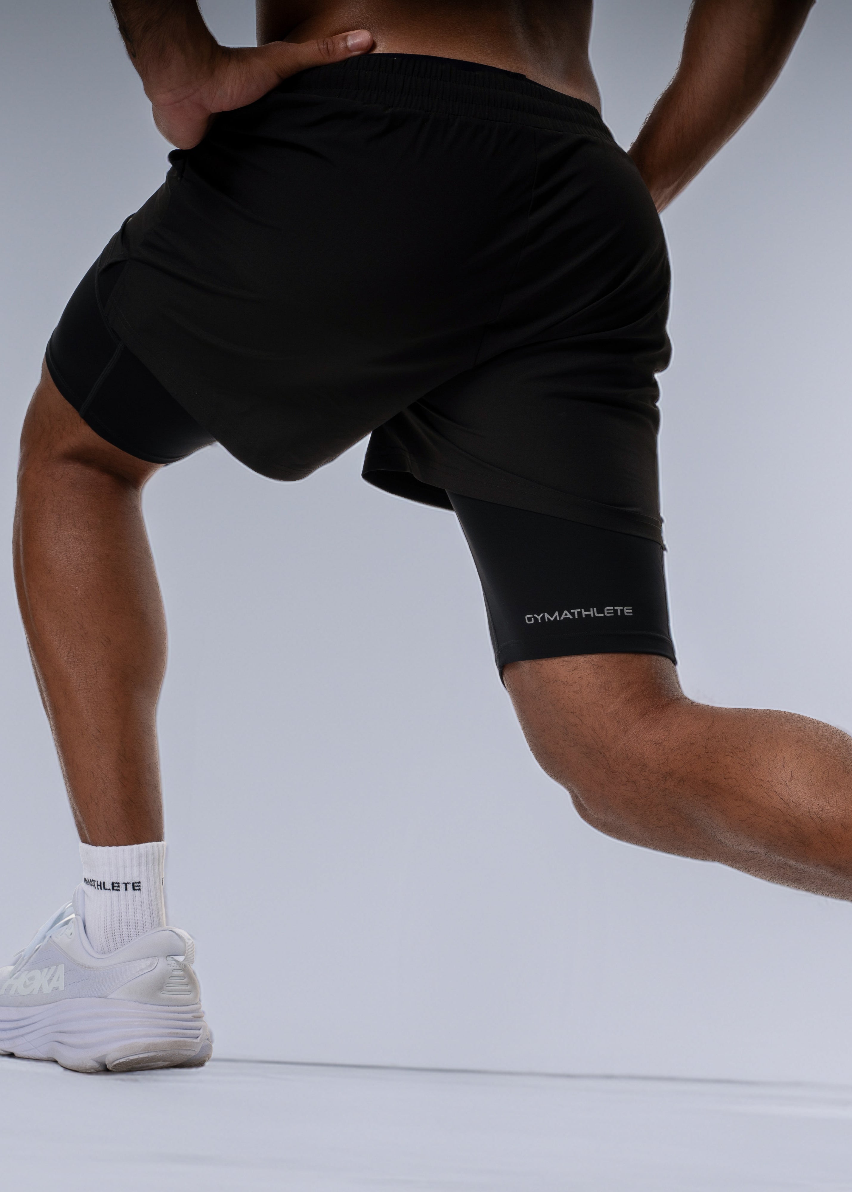 Man wearing black athletic shorts on a white background - Gymathlete 2in1 Shorts