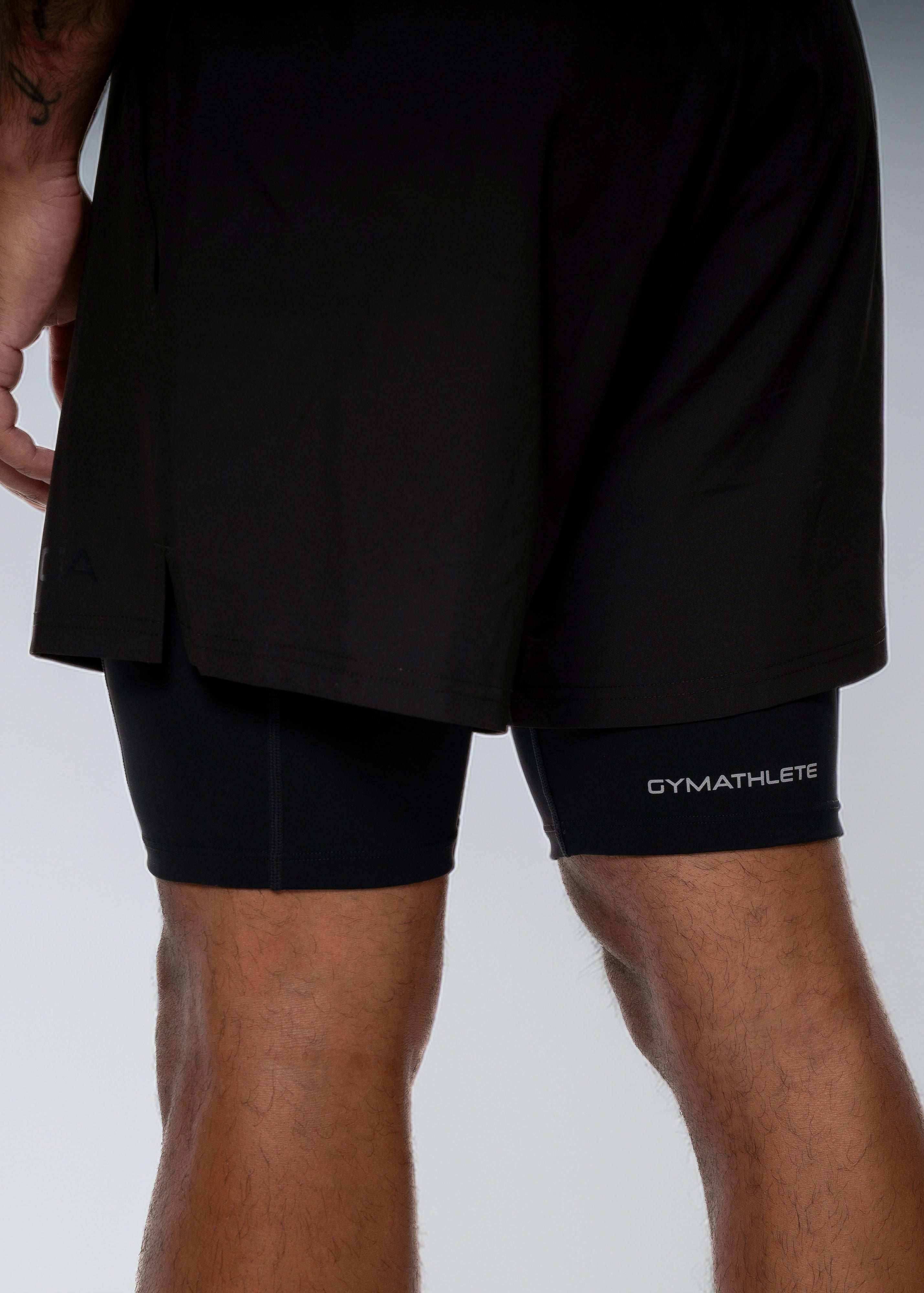 Man wearing black athletic shorts on a white background - Gymathlete 2in1 Shorts