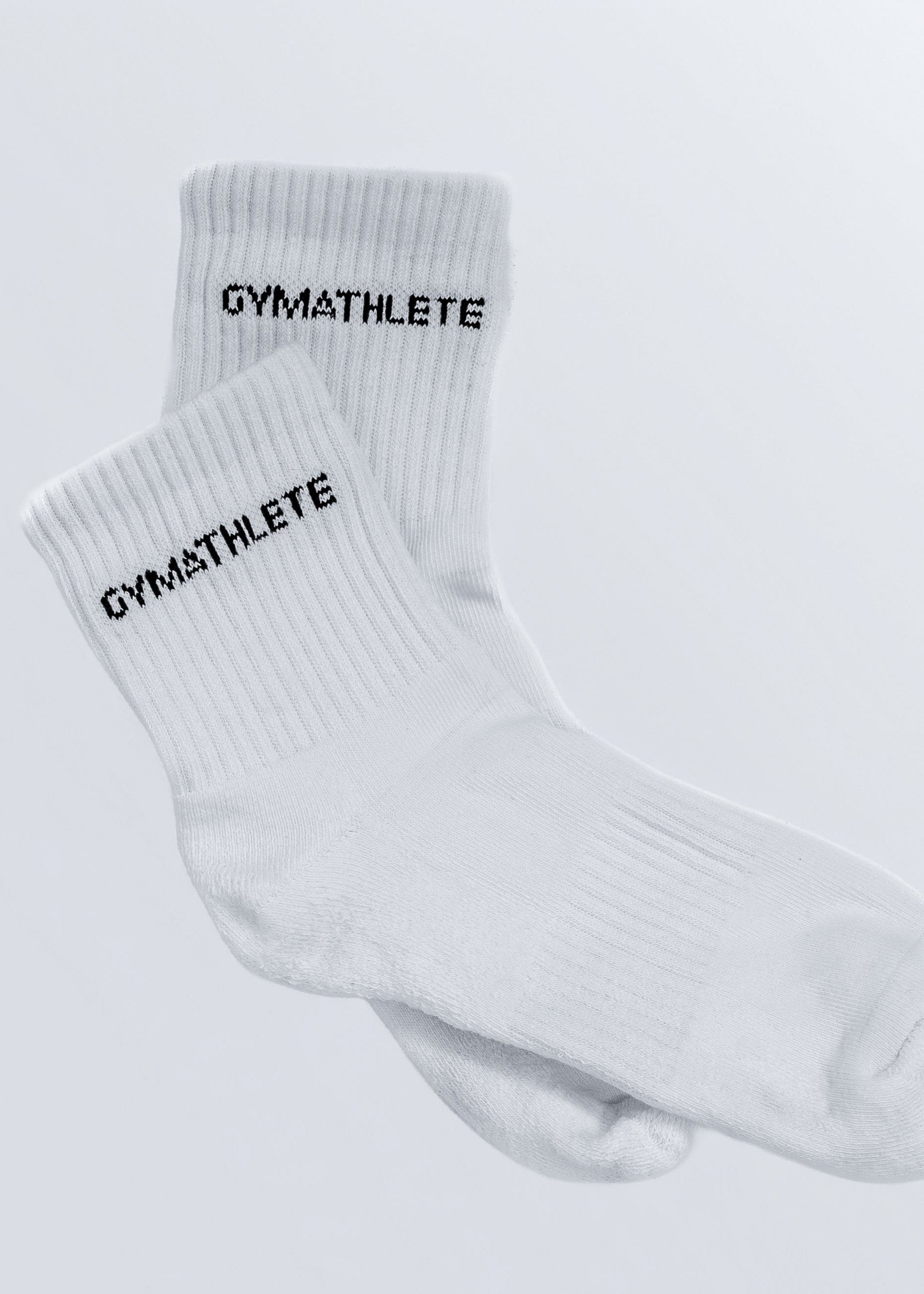 White socks with 'GYMATHLETE' branding on a light gray background - Gymathlete endurance socks