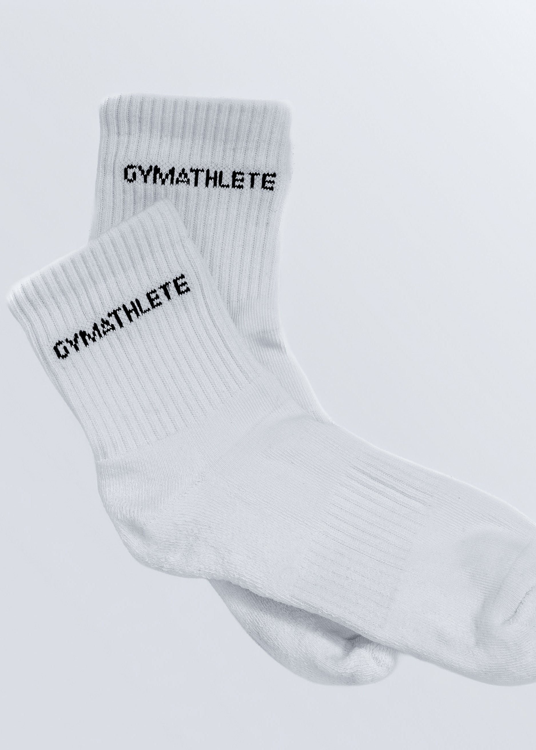 White socks with 'GYMATHLETE' text on a light gray background. Gymathlete - Endurance socks