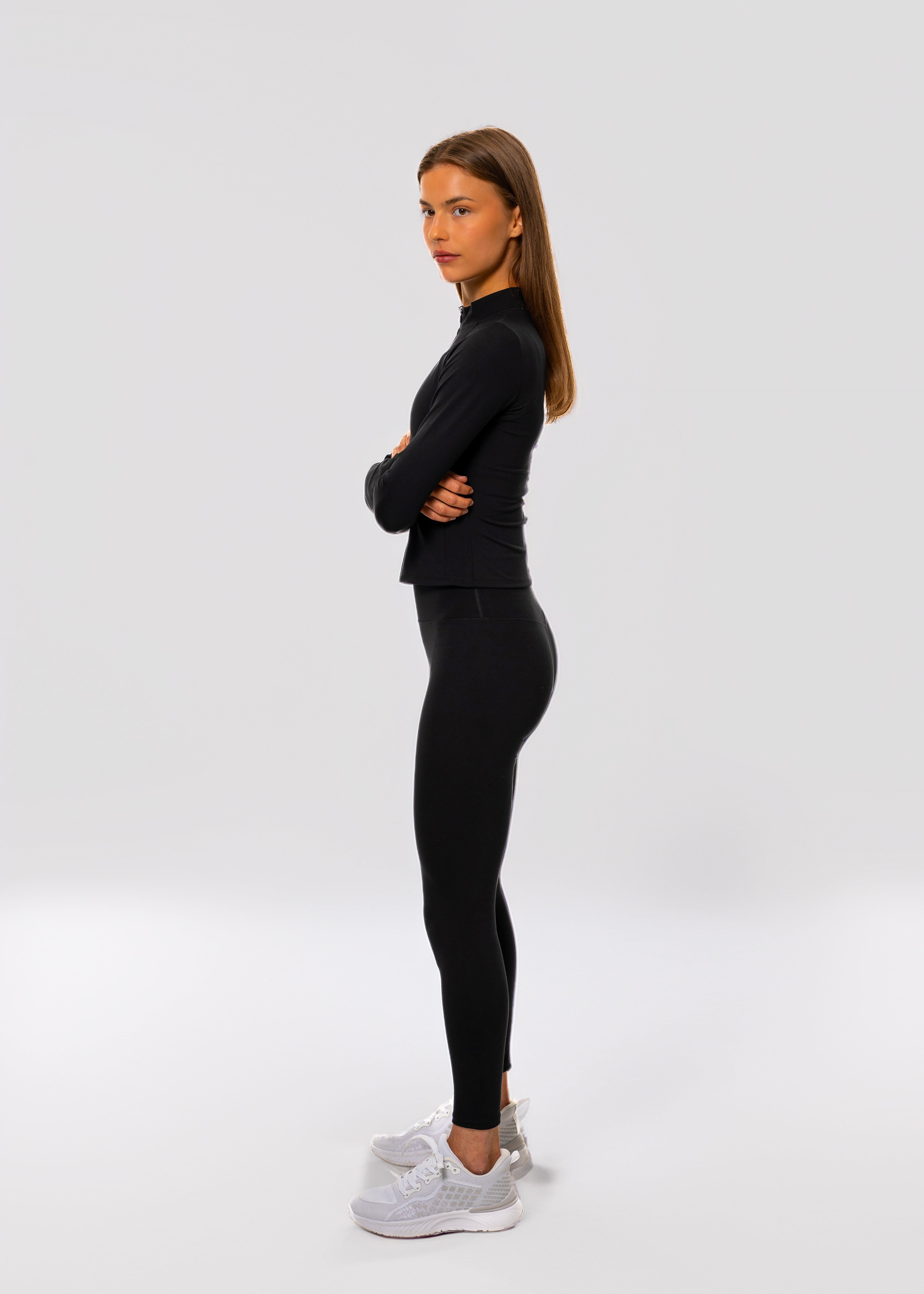 Person wearing a black outfit on a white background. Pulse leggings - women - Gymathlete.