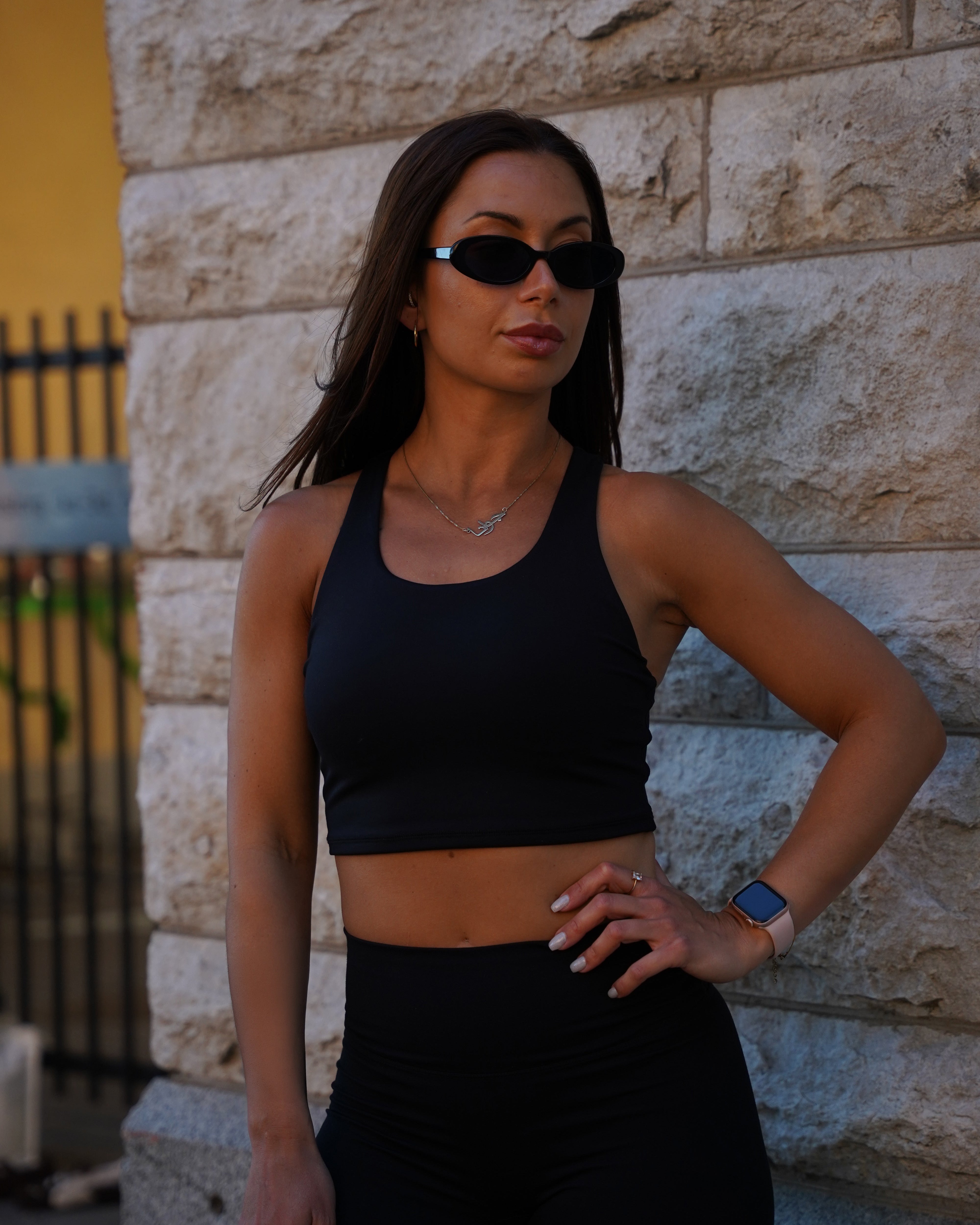 Close view of the Gymathlete Pulse Crop Top in black showing the cropped hem and second-skin fit