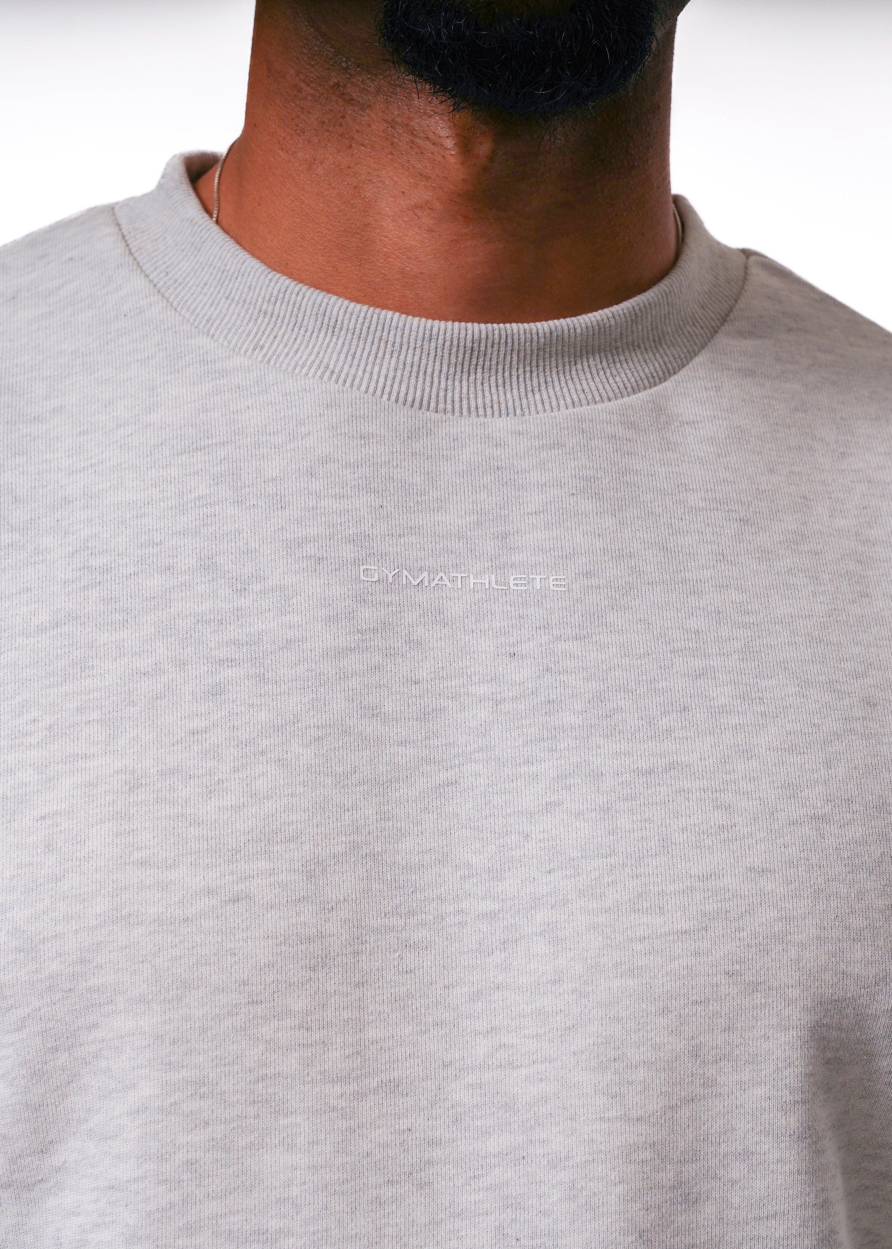 Person wearing a light gray sweater on a white background. Gymathlete, Elevate Sweatshirt