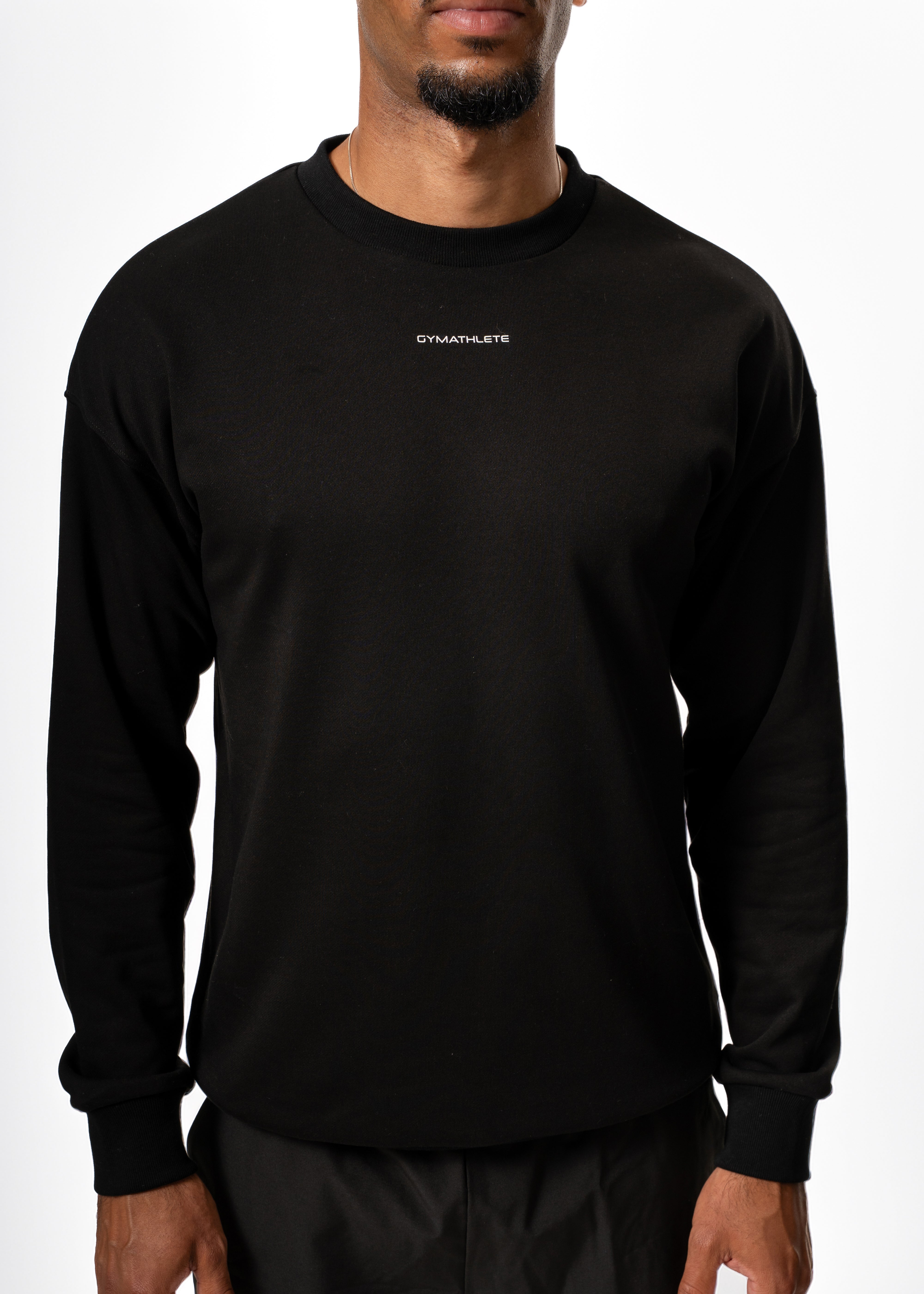 Man wearing a black sweatshirt and shorts with white socks on a white background. Gymathlete, Eelevate Sweatshirt