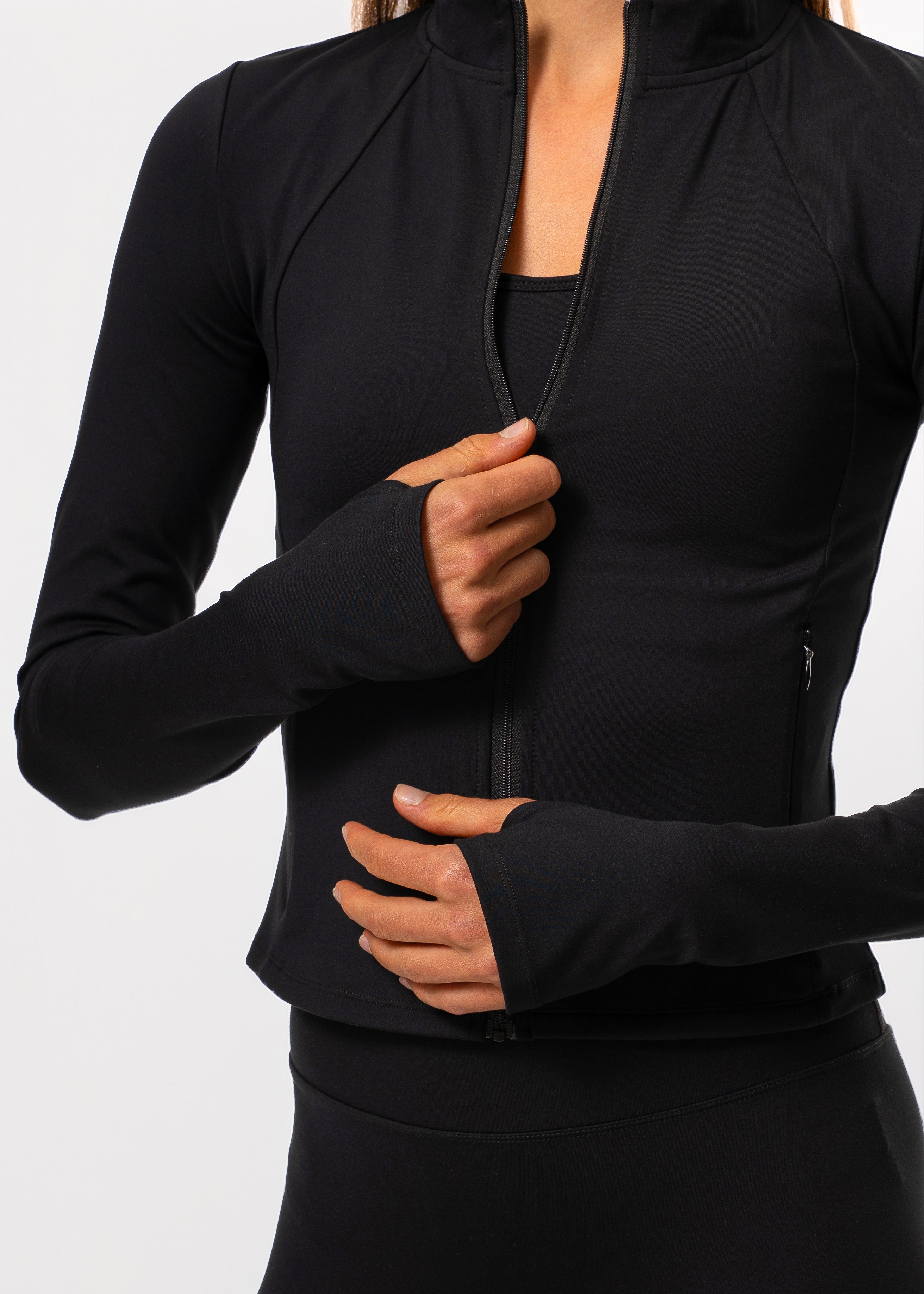 Woman wearing the Gymathlete Pulse Active Jacket in black. Activewear.